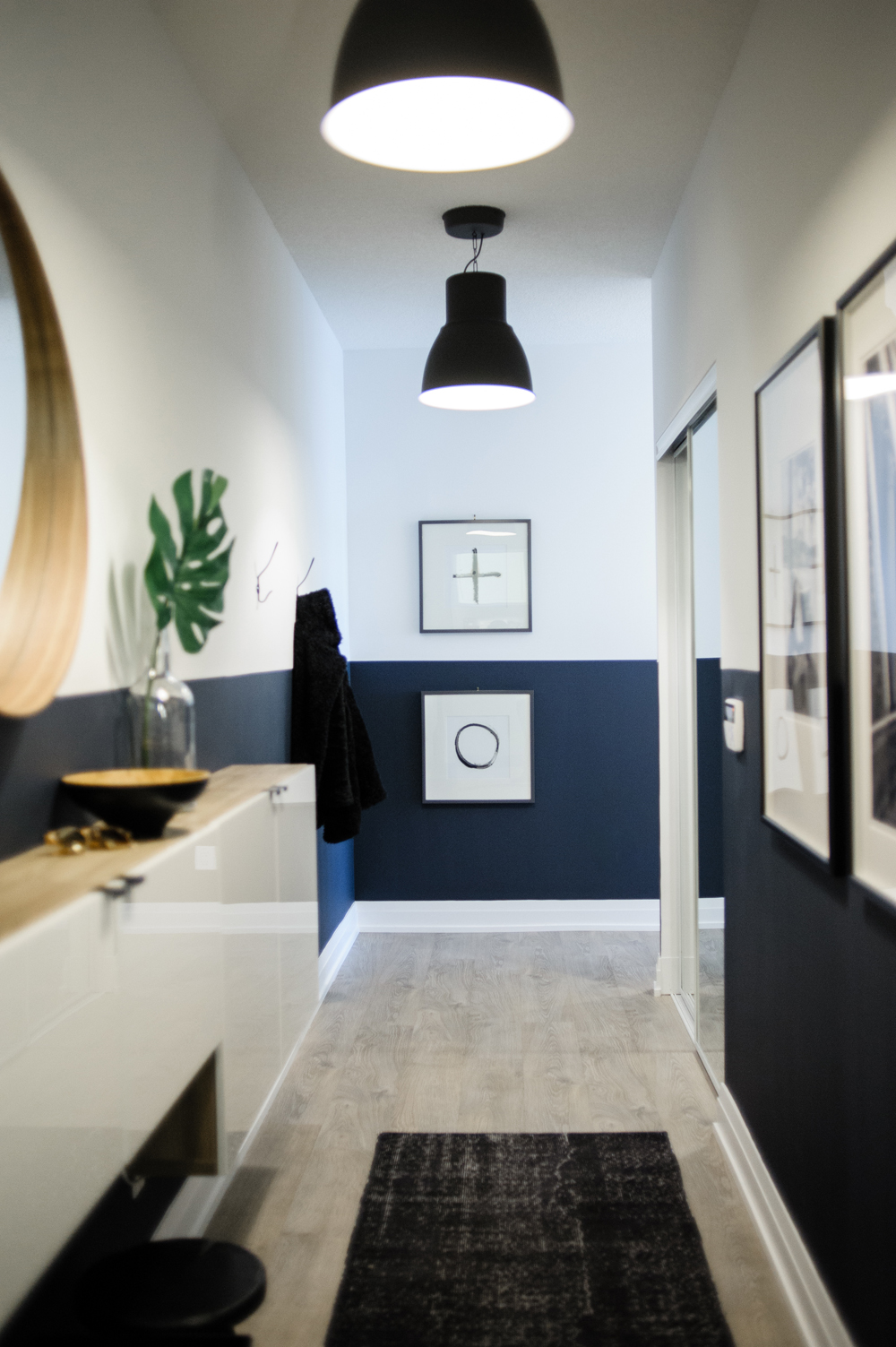 In this condo, large black pendant lights make a dramatic statement.