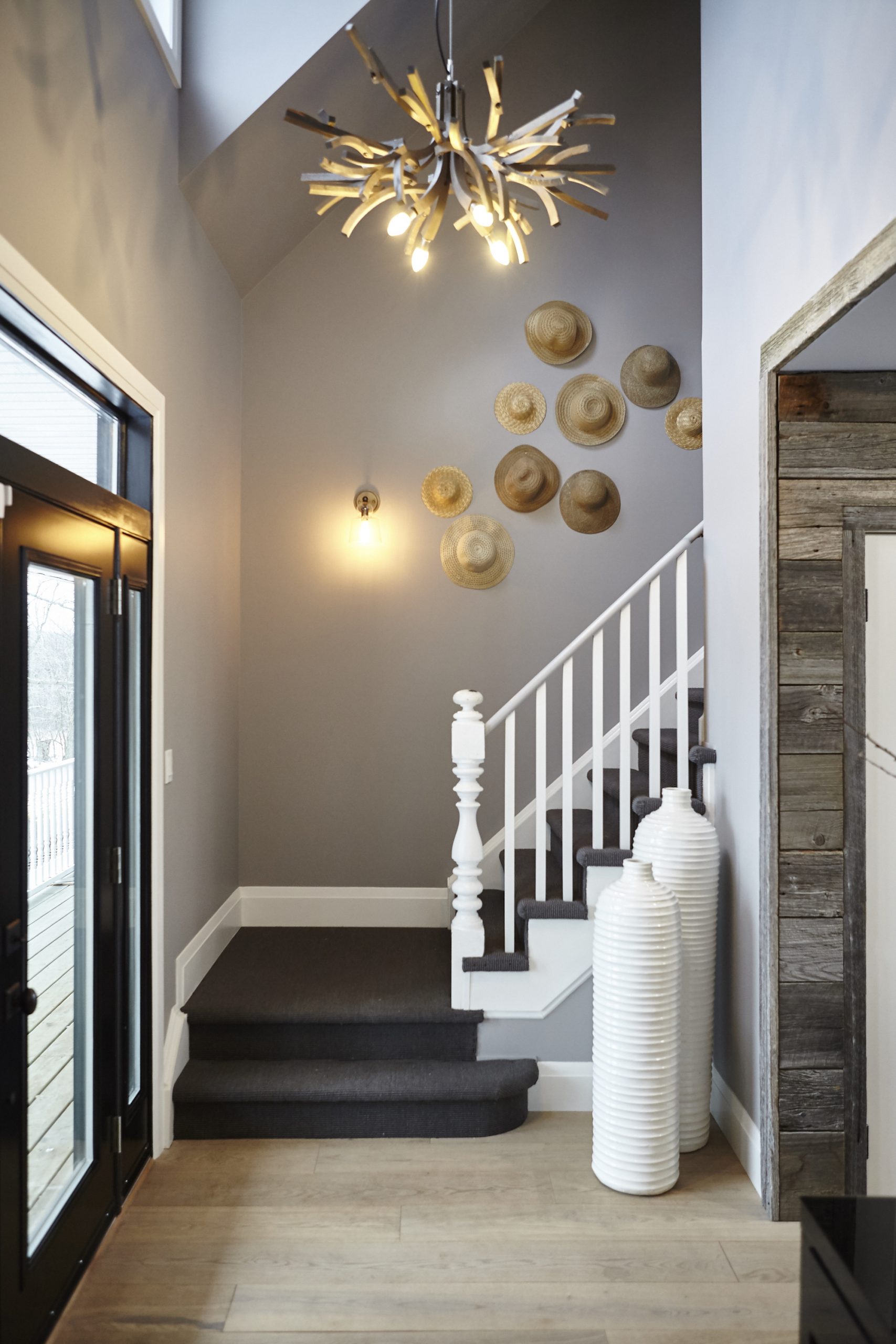 Fun foyer with grouping of hats on the wall as artwork.