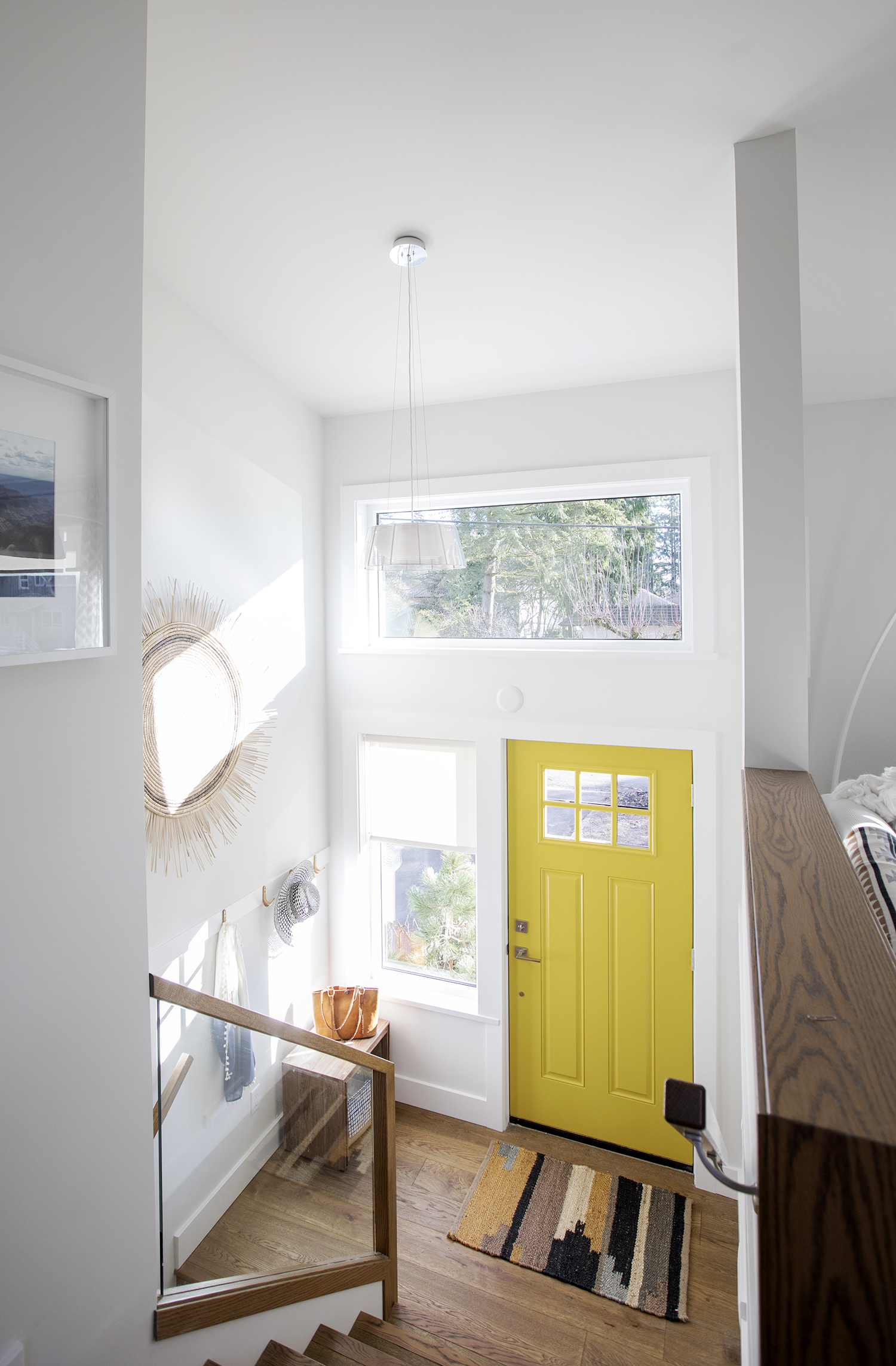 Small entryway with bright yellow front door.