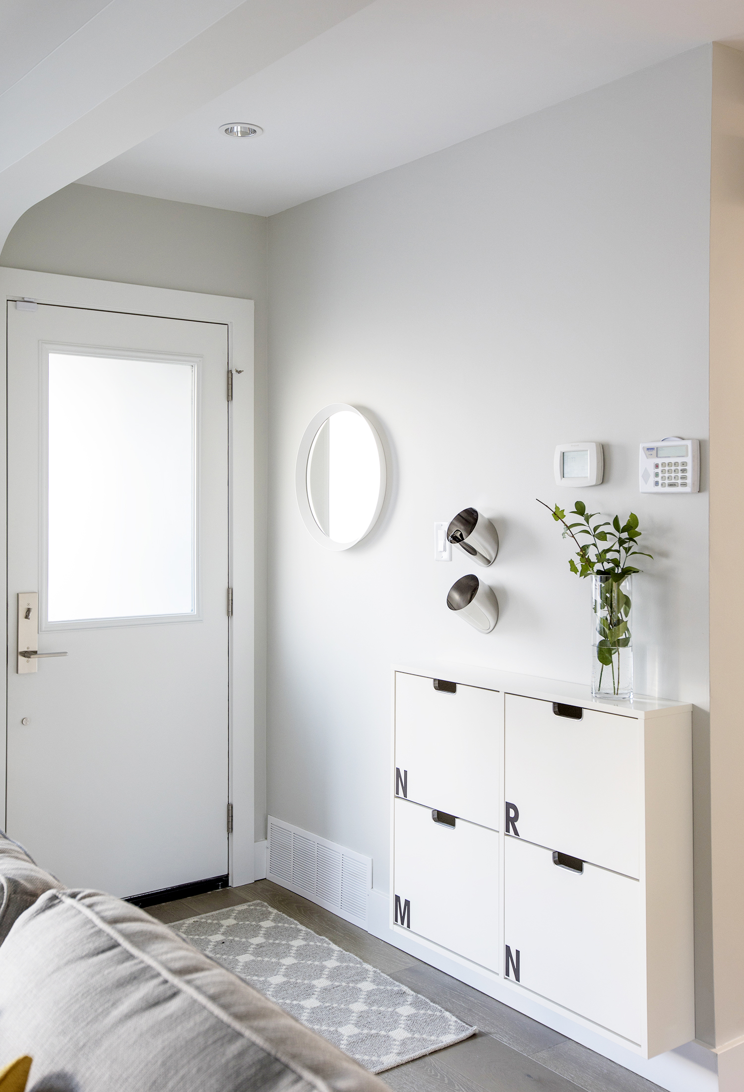 Small entryway with space-saving IKEA shoe cabinet.