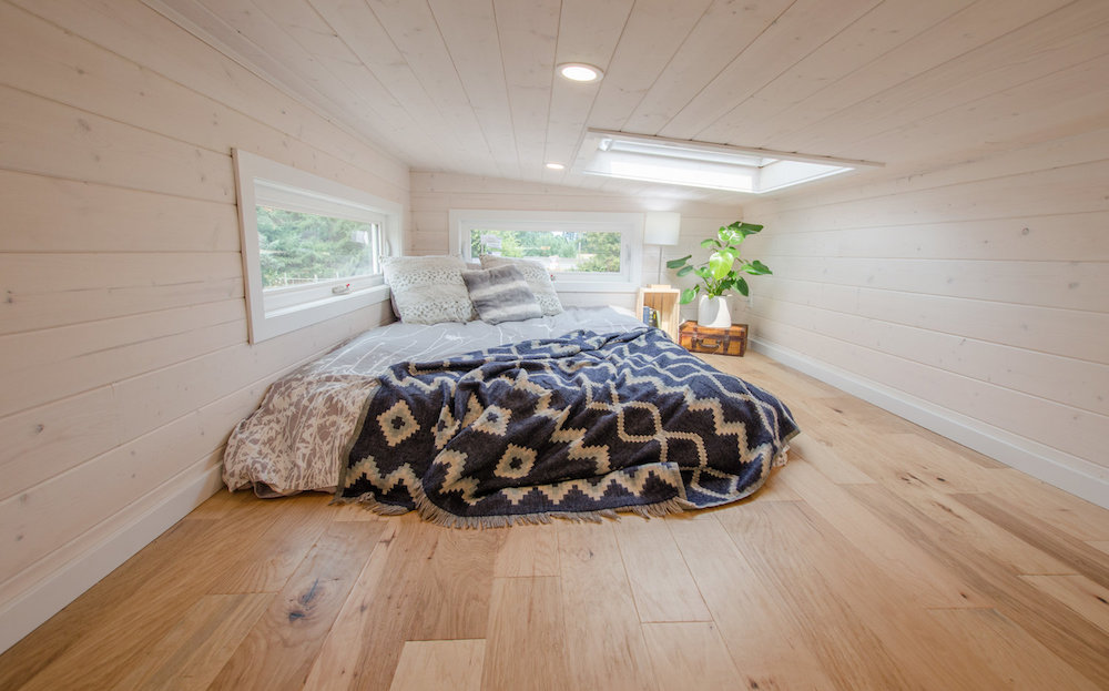 white-wall master loft with skylight in tiny house