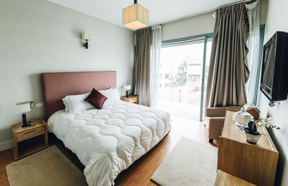 bedroom with a tv mounted on the wall