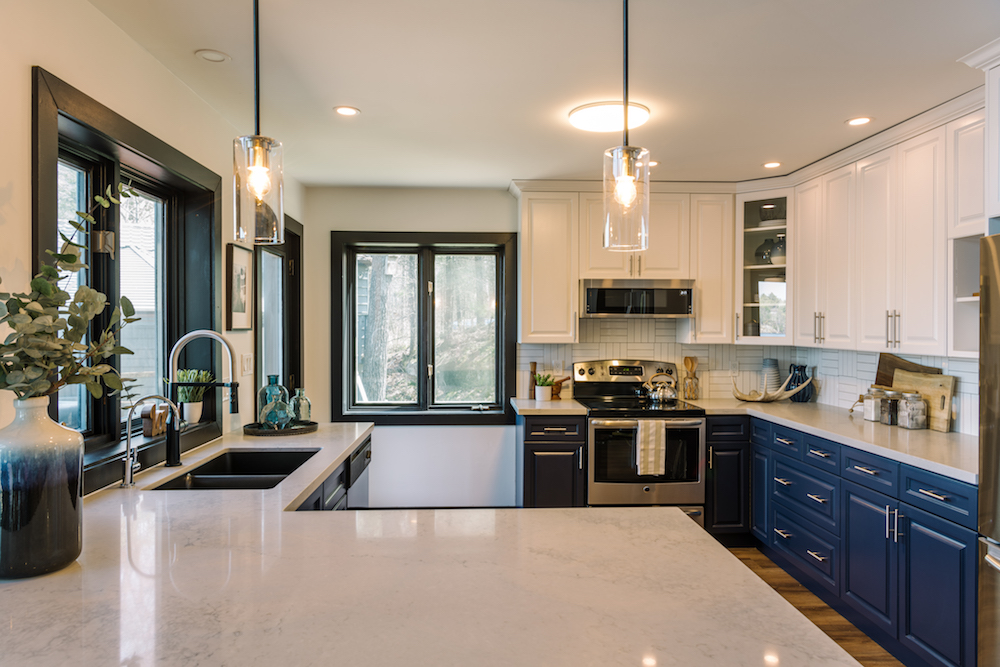 Upgraded kitchen with blue cabinets and white countertops