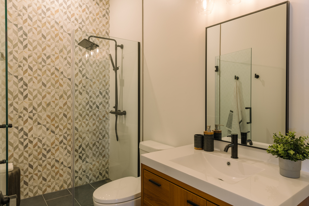 Updated bathroom with walk-in shower and unique wall tiles