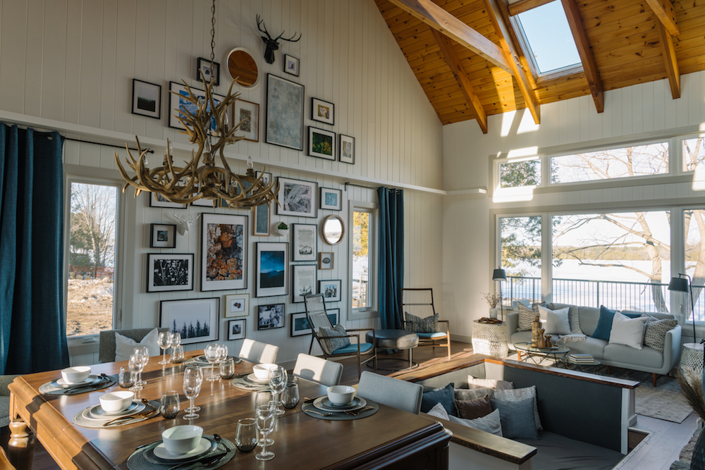 Vacation home dining room with high ceiling and decorative photo wall