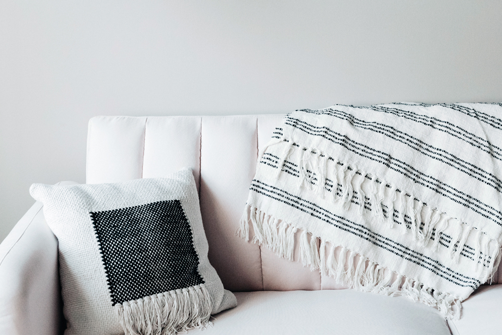 a throw blanket on a white couch