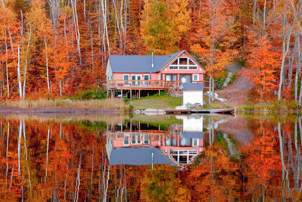 Cottage surrounded by autumn leaves