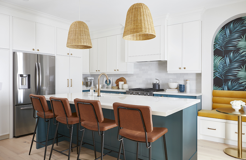 Tropical Paradise A white kitchen with pops of colour in the kitchen island and tropical-inspired wallpaper in the breakfast nook