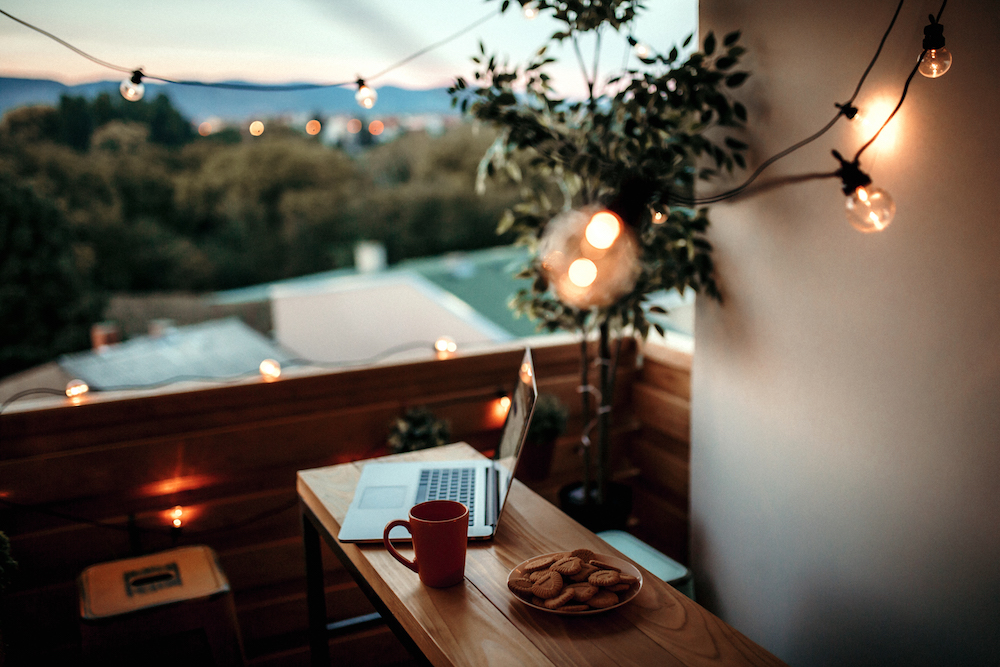 balcony with string lights and plate of cookies