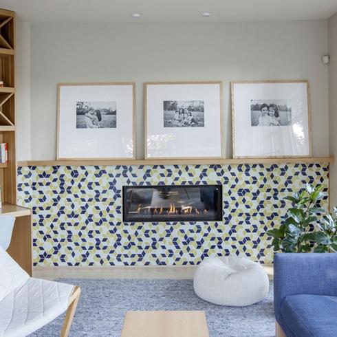 Living room with colourful tiles, framed art and a fireplace