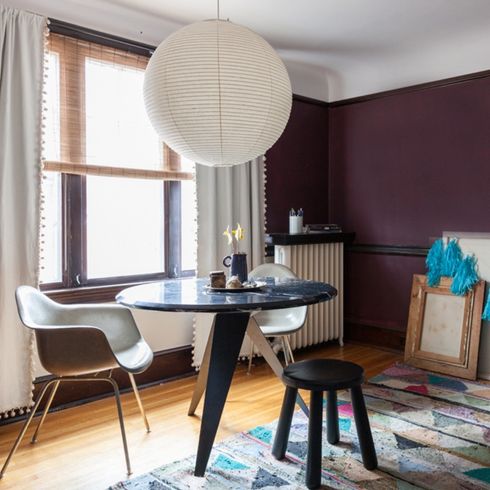 A breakfast nook with a dark accent wall