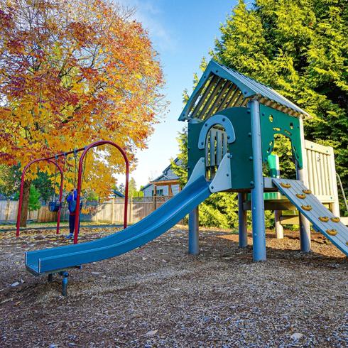 A kid's jungle gym in a backyard