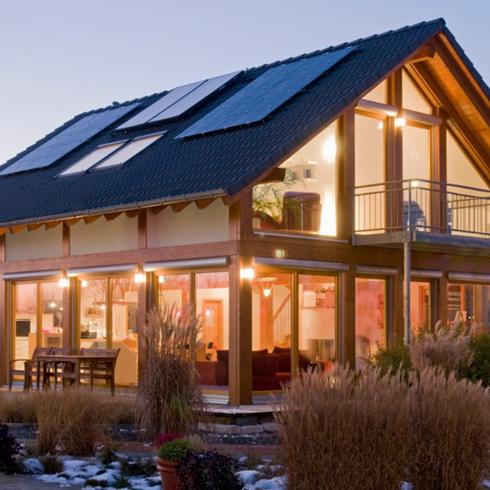 A house exterior with solar panels on an A-frame roof