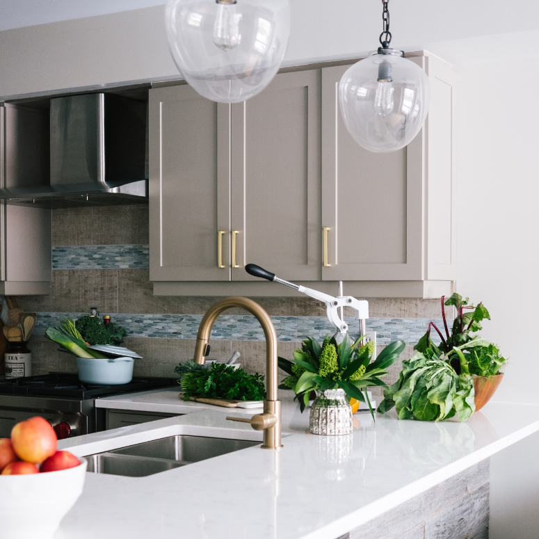 Grey kitchen cabinets with gold hardware