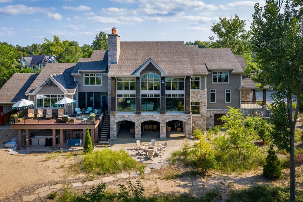 A luxury beach house with a fire pit, spacious outdoor deck and swing.