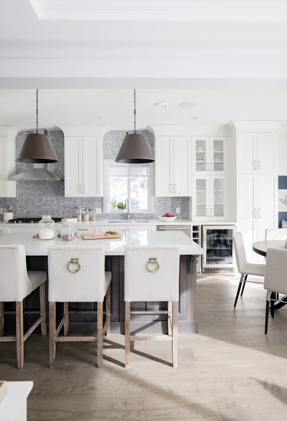 All in the Details Modern white kitchen with exotic backsplash tiles.