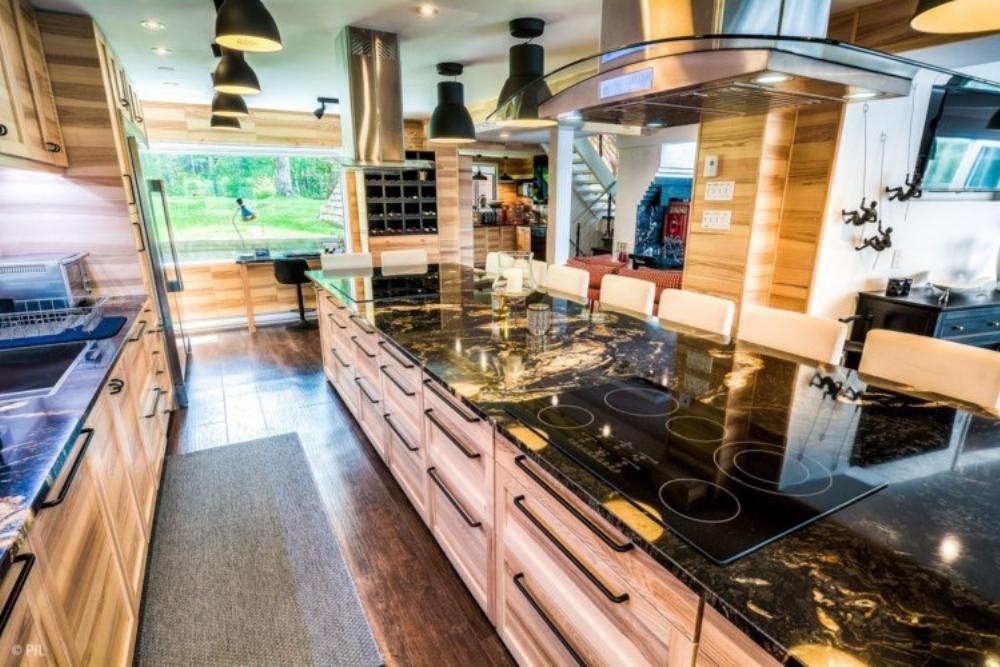 A luxury kitchen with a black marble island.