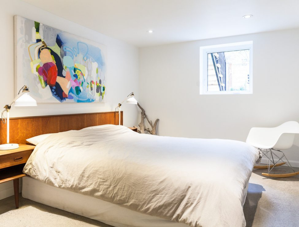 Funky basement bedroom with teak headboard