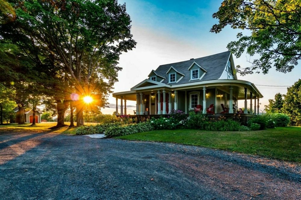 A cozy craftsman home with a big garden serves as the perfect quaint Canadian cottage from which to view the setting sun.