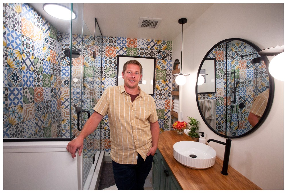 Randy standing in a bathroom with colourful tile