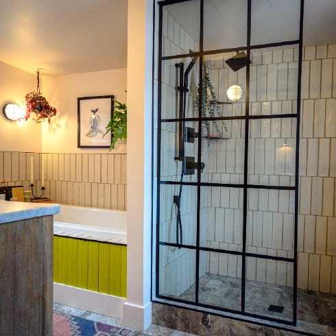 Modern bathroom with glass shower and lime green bathtub