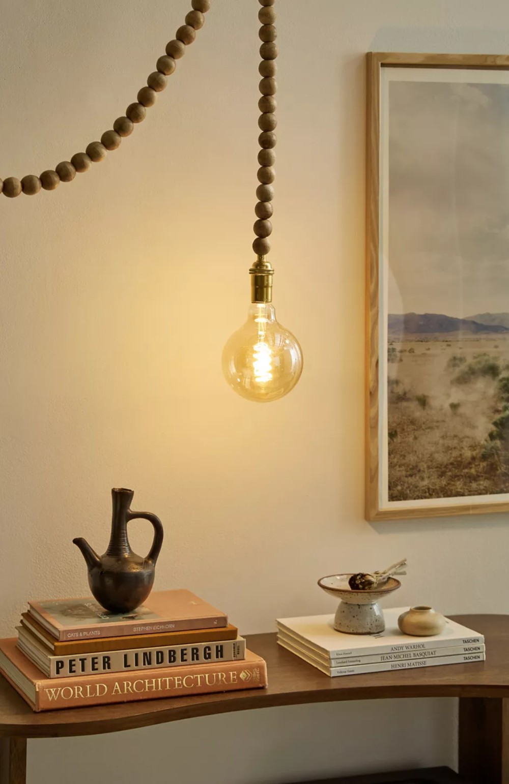 Beaded pendant light cord hanging over desk