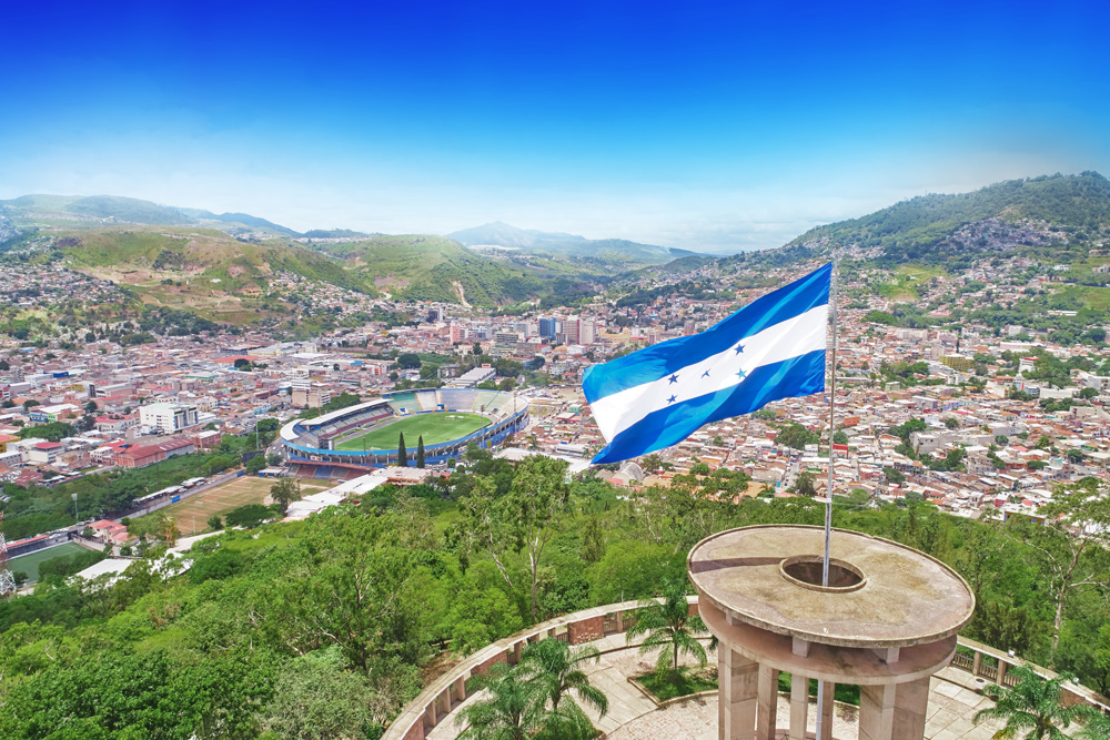 the Honduras flag flies over the capital