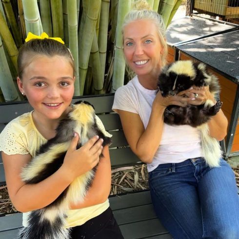 Jojo and Sarah holding skunks