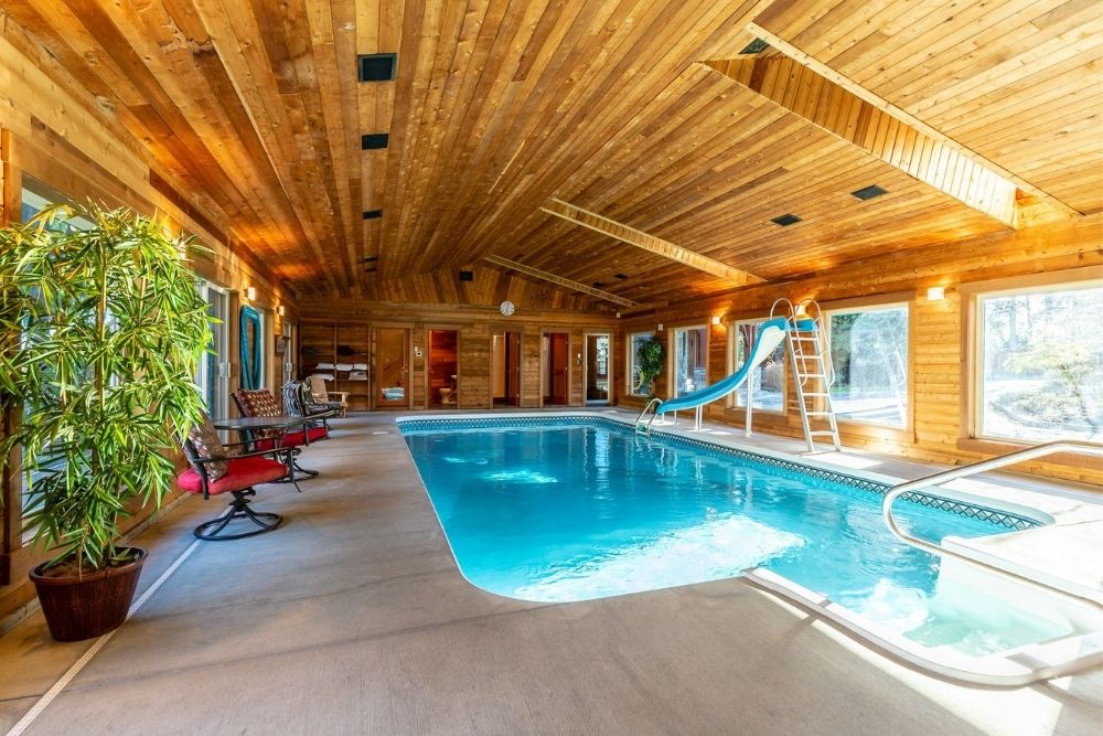 An indoor swimming pool with a blue slide.