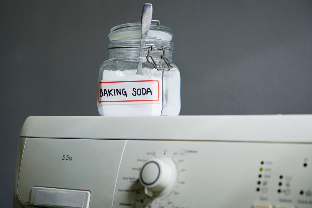 jar of baking soda on a washing machine