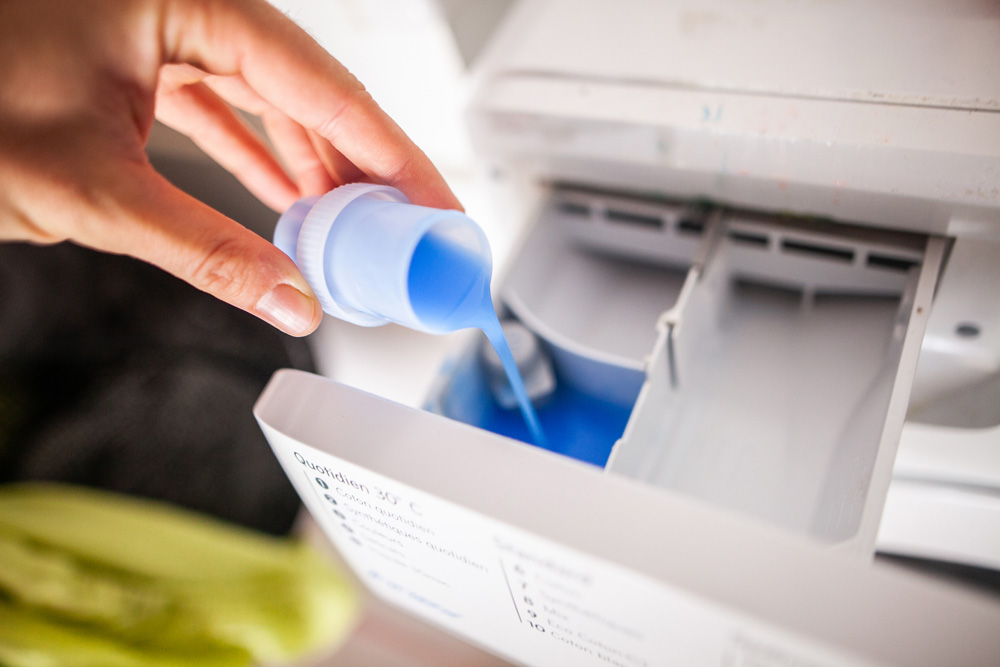 Pouring detergent in a washing machine