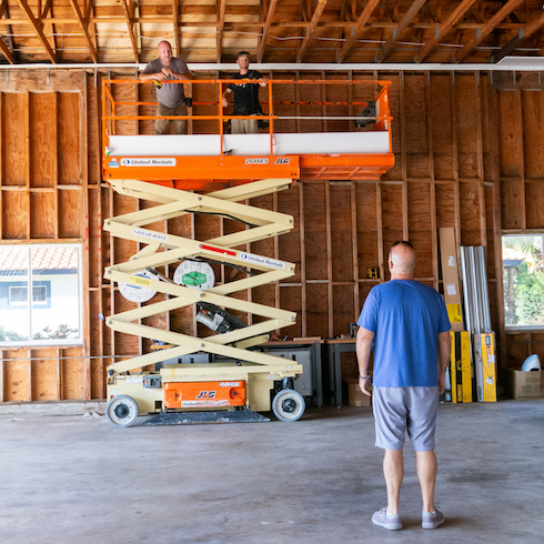 Bryan Baemler looking at a lift in a hangar