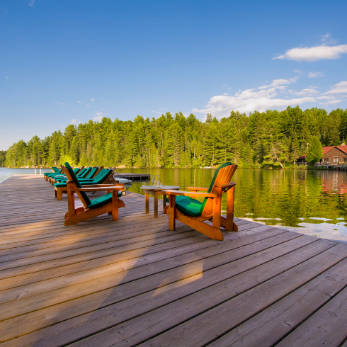 two muskoka chairs on lakehouse dock