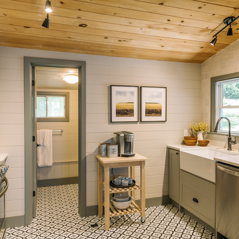 Updated farmhouse kitchen with grey cabinetry and walls