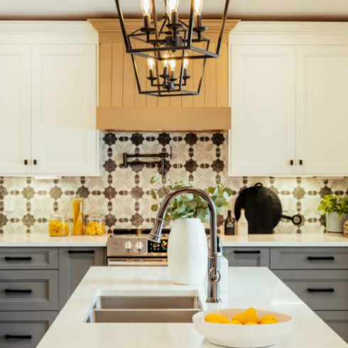 Kitchen with white walls, blue cabinets and white counters