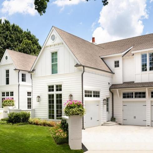 White house with a three-car garage and large driveway