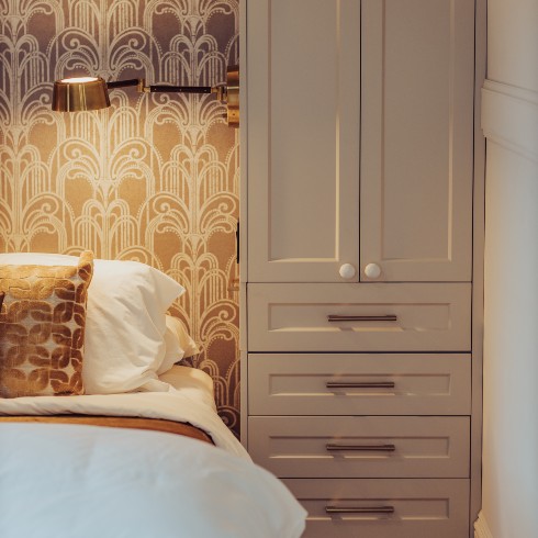 Bedroom with elegant wallpaper across the ceiling