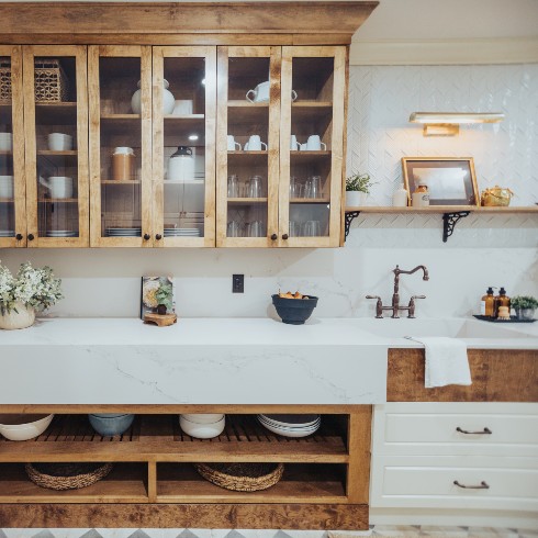 A warm wood shelving unit in the kitchen