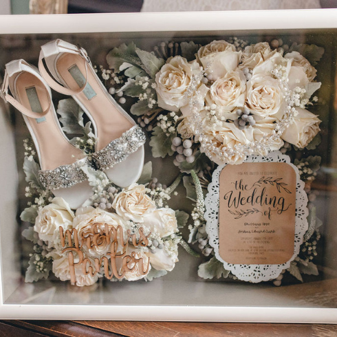 A memory box of wedding shows and flowers.