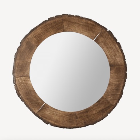 Live edge wood round mirror on white wall.