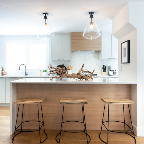 Renovated vacation house kitchen with a 3-seat island