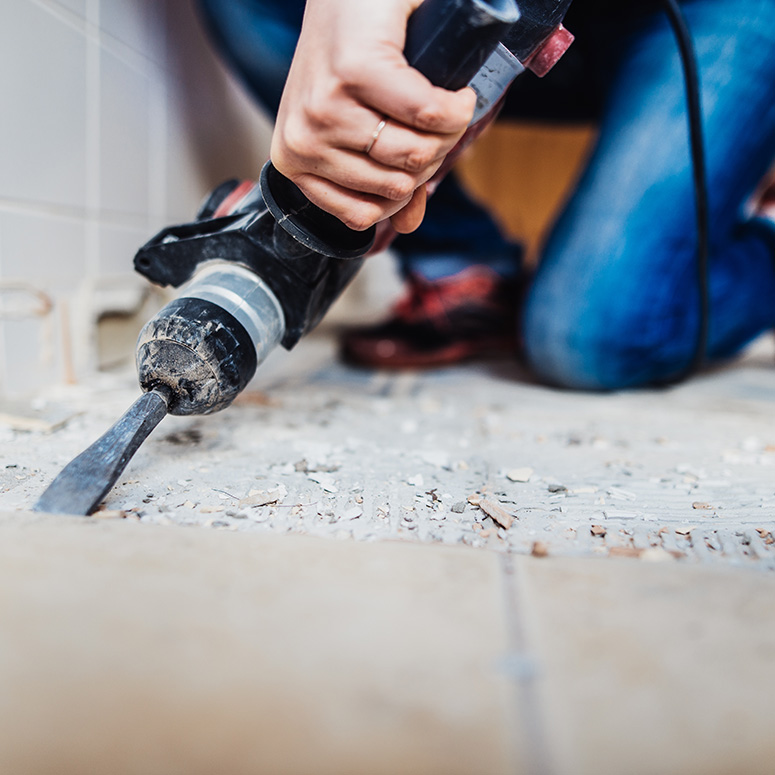 person tearing out a floor