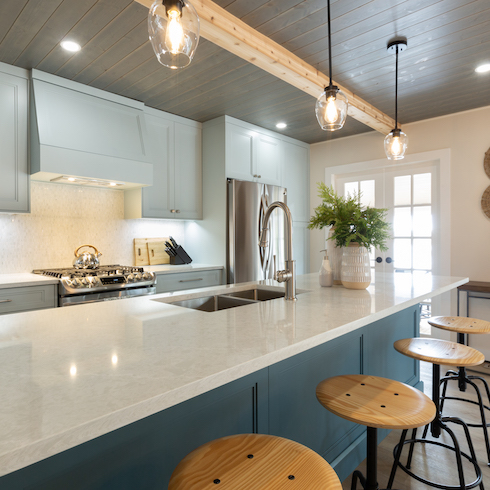 Modern cottage kitchen with a large blue kitchen island and cabinets