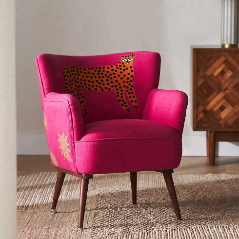 Hot pink armchair with a cartoon cheetah