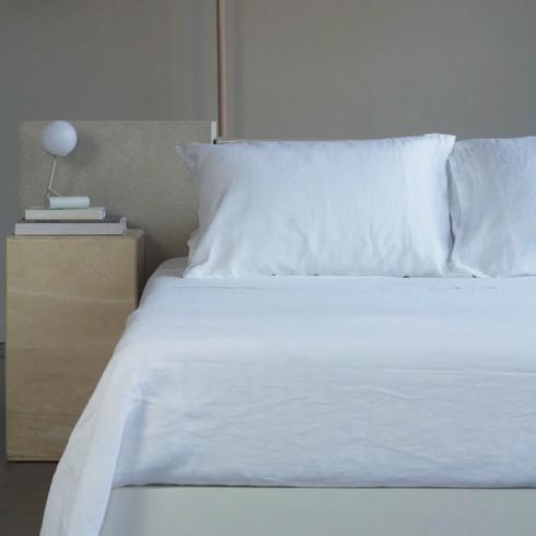 White bedsheets in a modern bedroom.