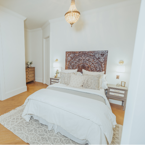 Primary bedroom with elegant chandelier