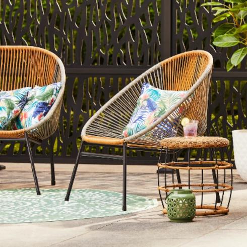 Two egg chairs on a deck.