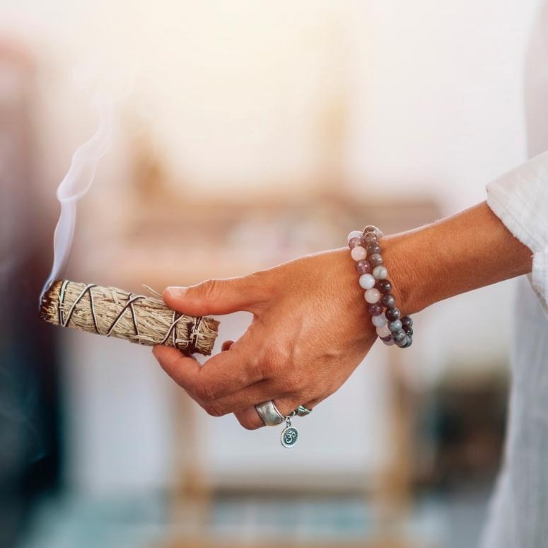 Woman holding a bundle of sage
