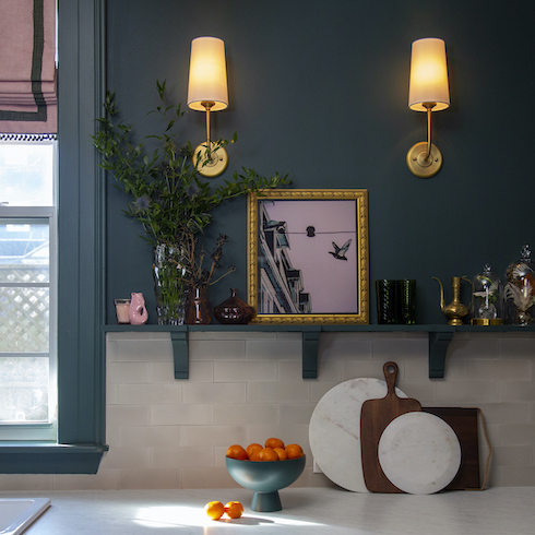 Kitchen with modern-vintage charm features brass wall sconces, a brick-patterned concrete backsplash, a functional and stylish) shelf tops a partial backsplash for a custom look by Rock Solid Builds