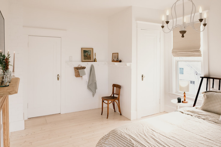 White guest room with antique furniture